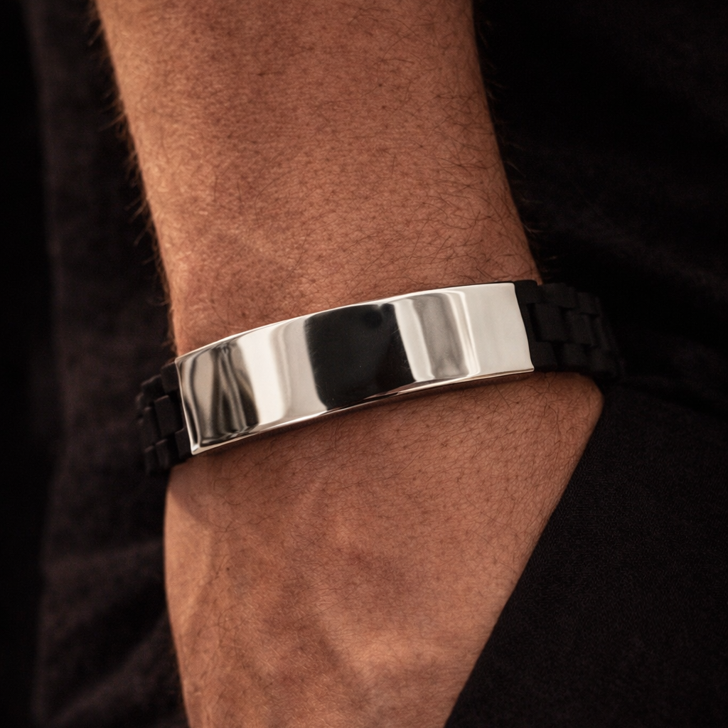 Silver bracelet on a wrist with a dark background