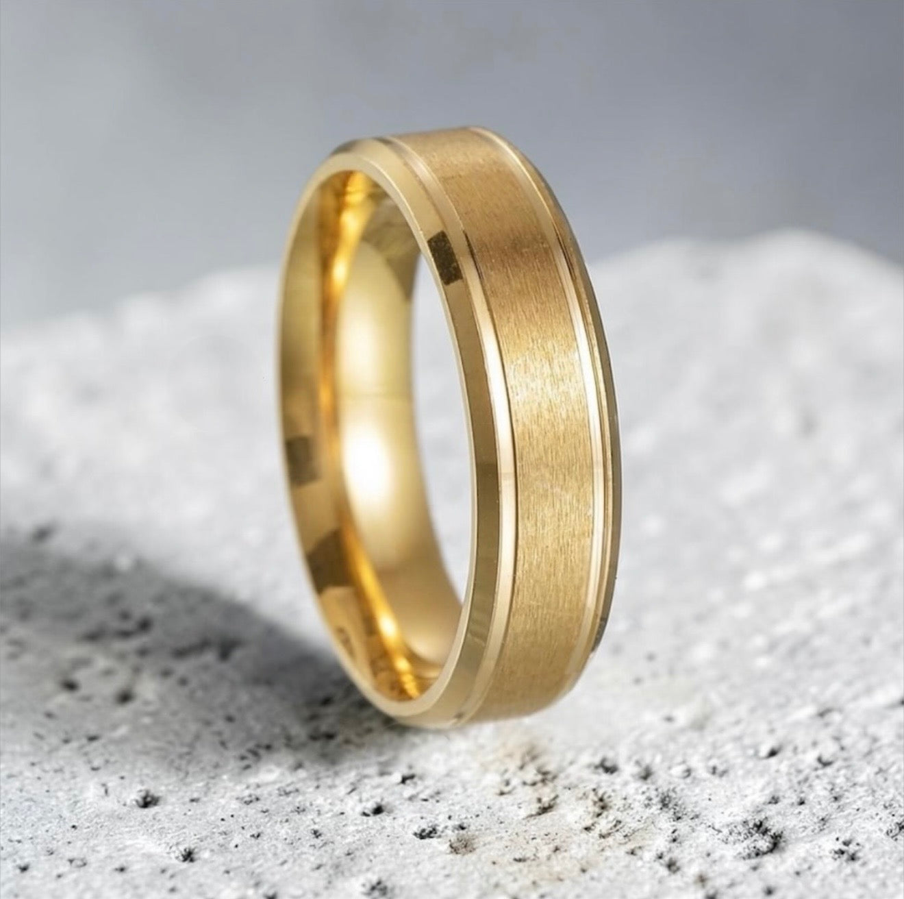 Gold ring on a textured gray surface