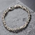 Silver bracelet on a textured gray surface