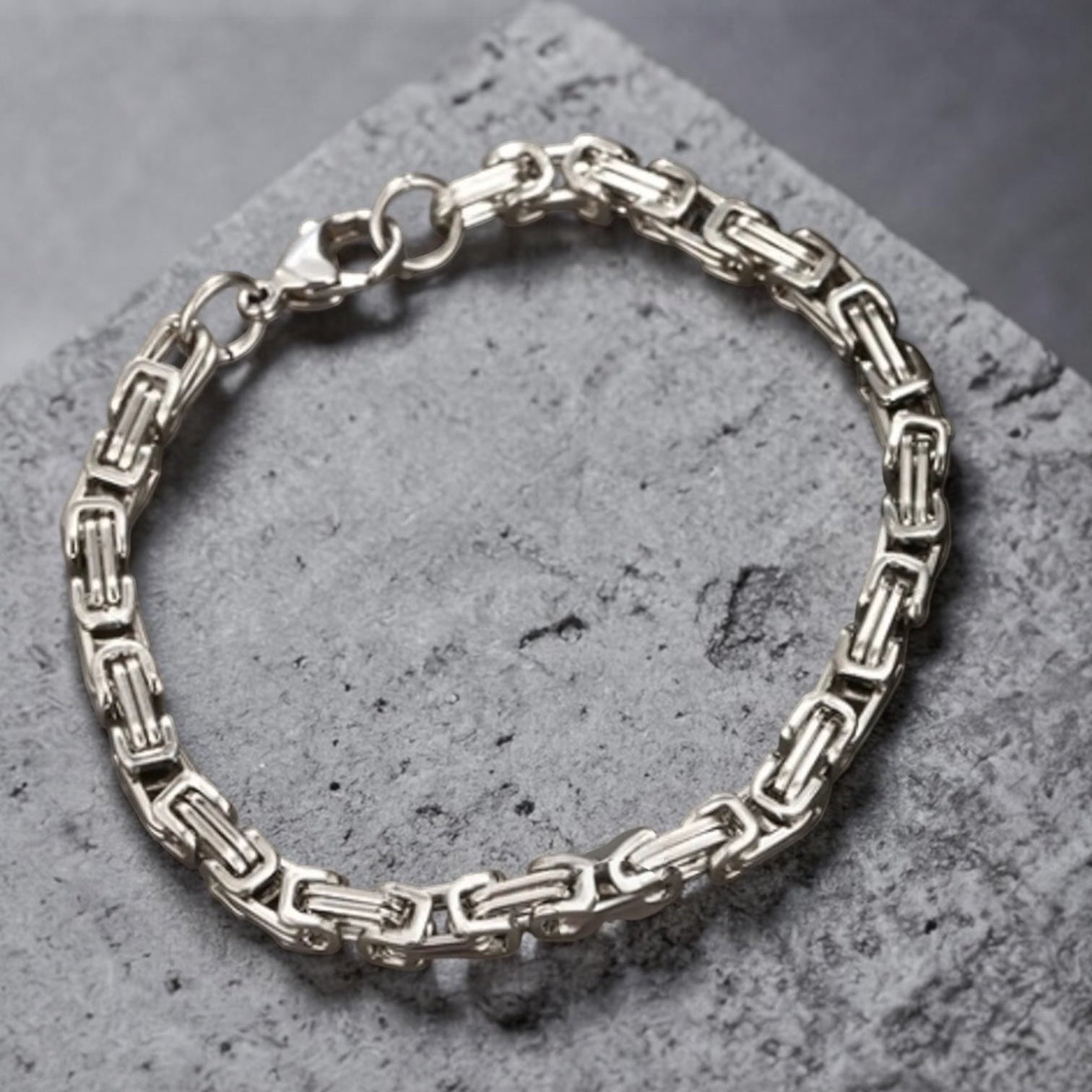 Silver bracelet on a textured gray surface