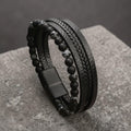 Black leather and beaded bracelet on a textured stone surface